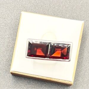 A Sterling Silver ring with two Bezel-Set and princess-Cut Garnets.